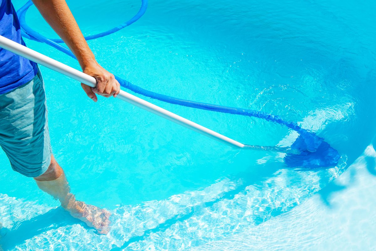 Man cleaning the pool with pool filters