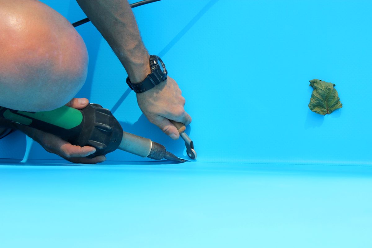 man welding pool liner to pool